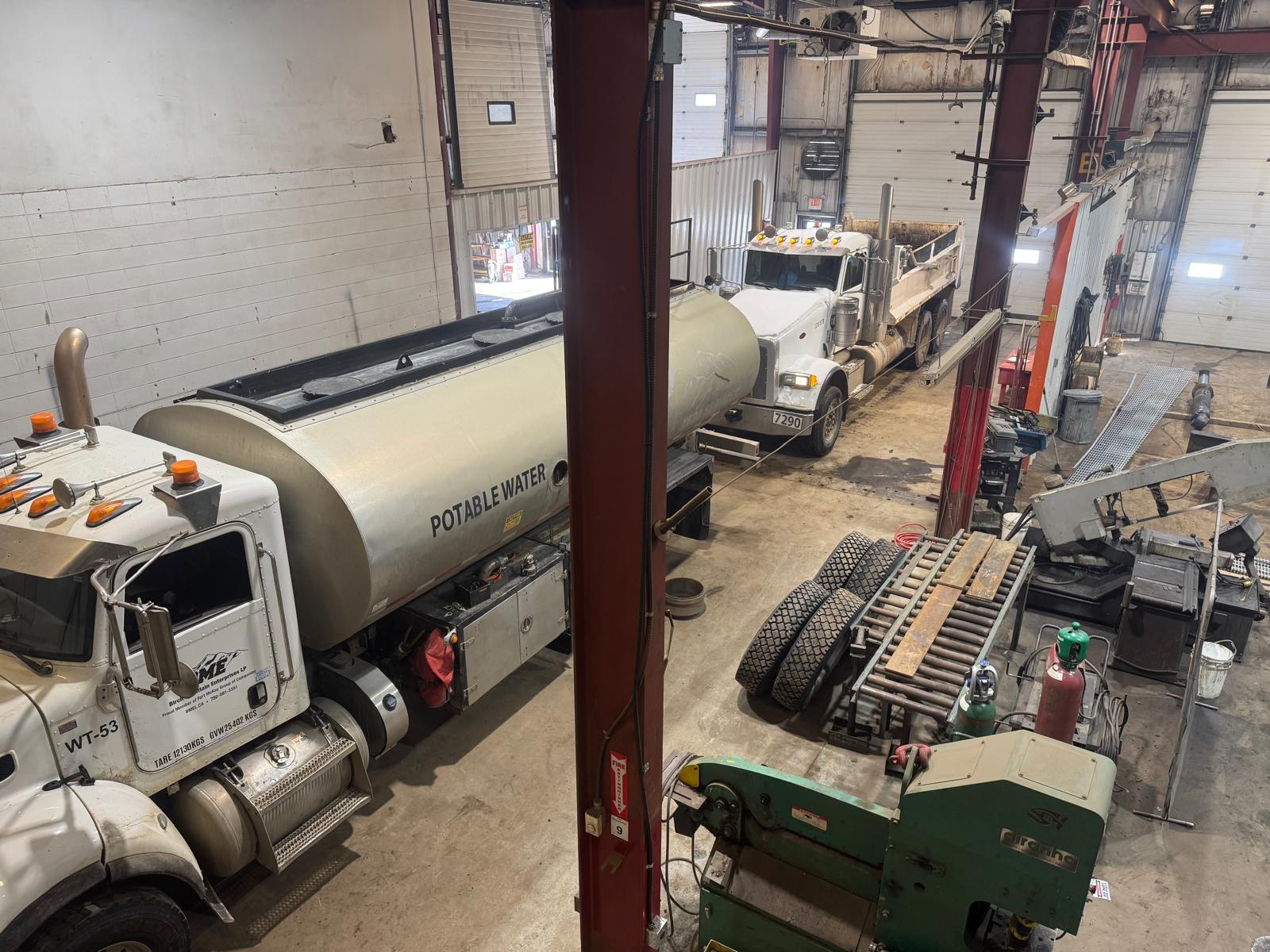 CIMW shop floor — commercial trucks in for service and CVI